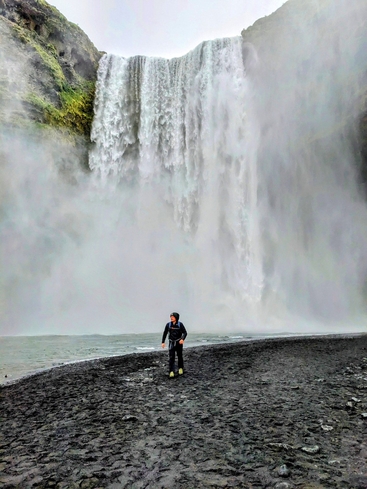 David standing in front of a huge waterfall in Iceland